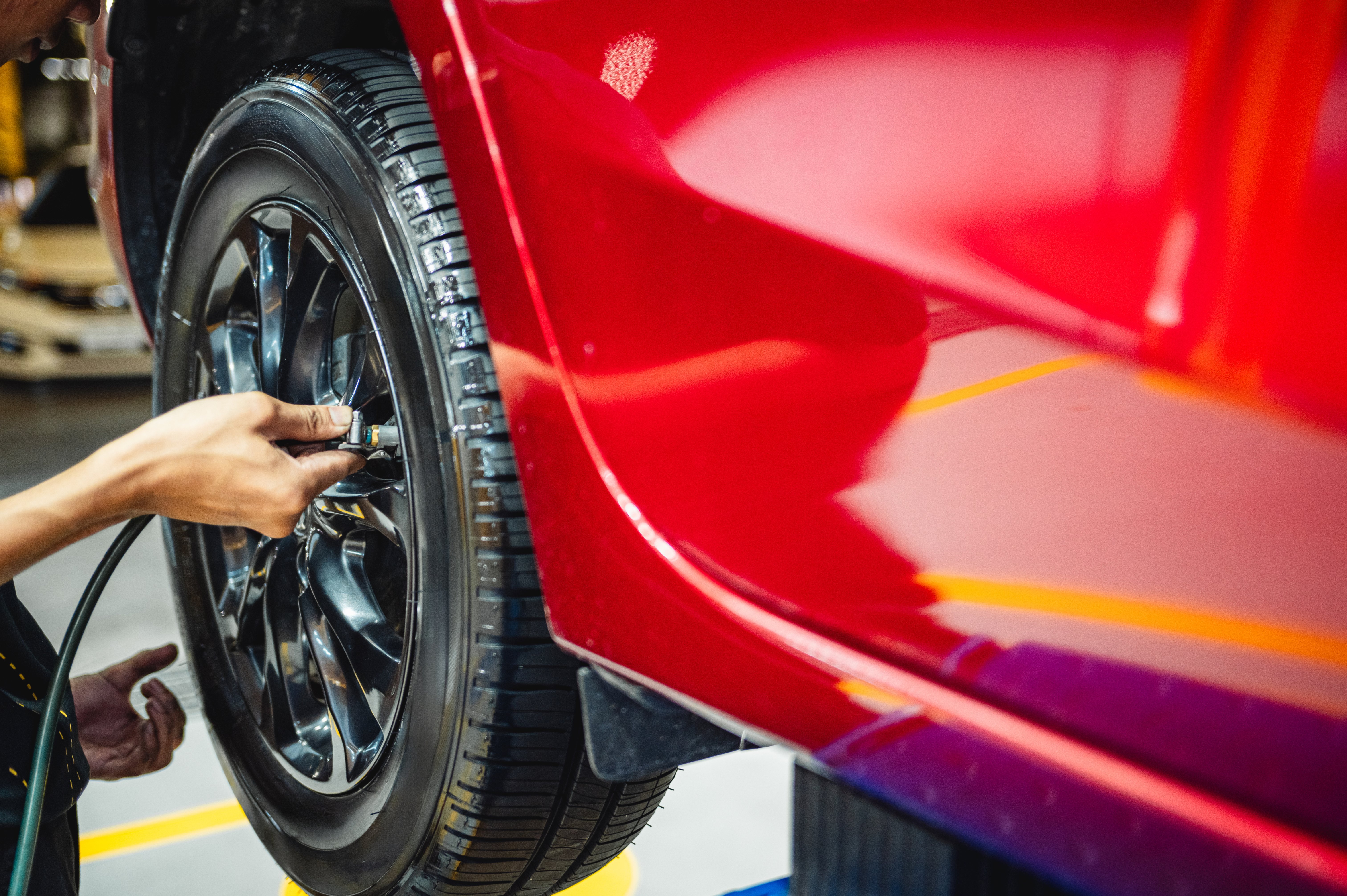 Technician inspecting a vehicle tire during a professional inspection