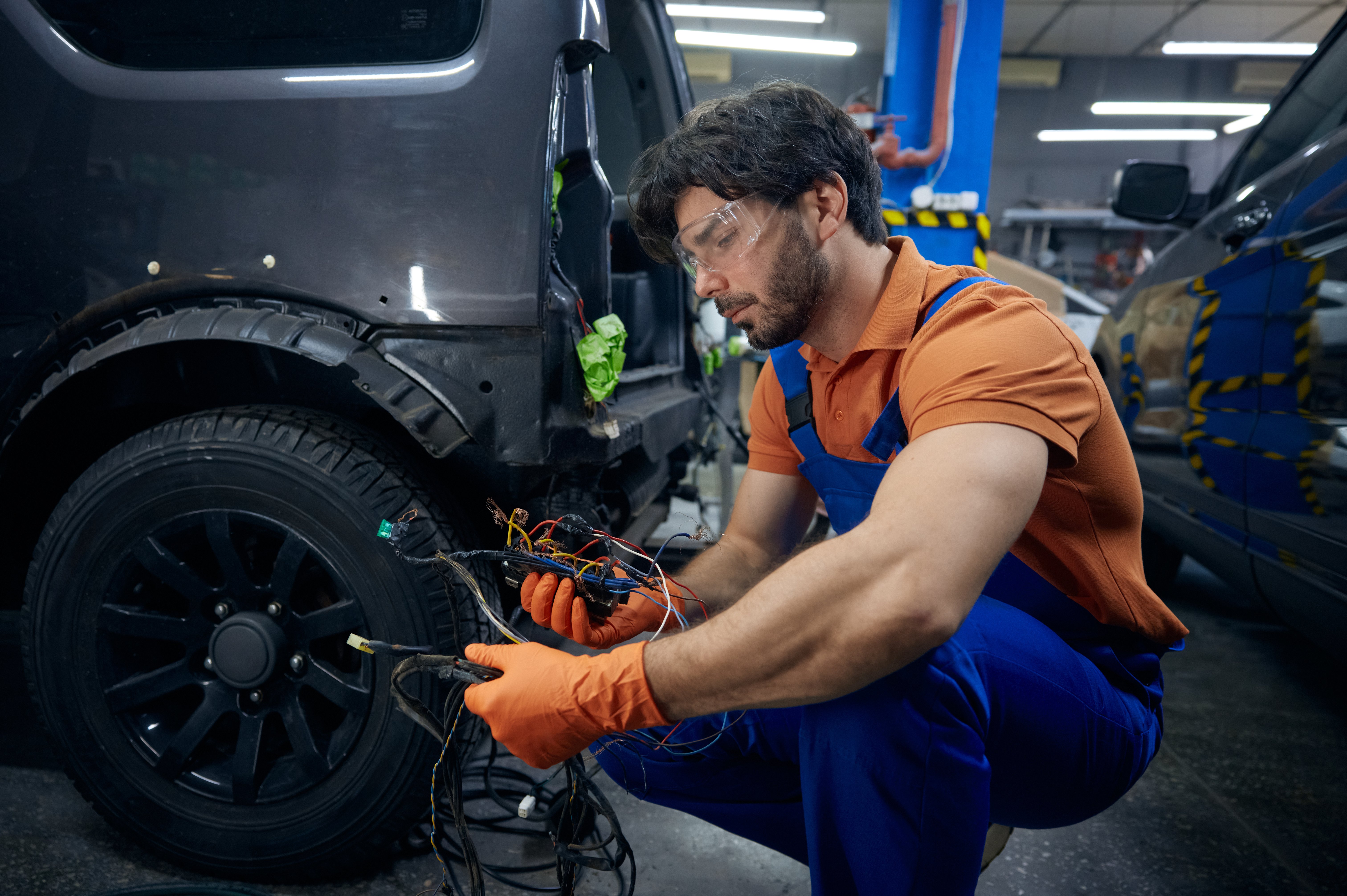 Mechanic performing an electrical diagnostic on a vehicle